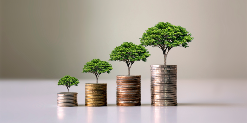 Trees sitting on stacks of coins, showing how real estate is the best long-term investment to grow wealth over time.